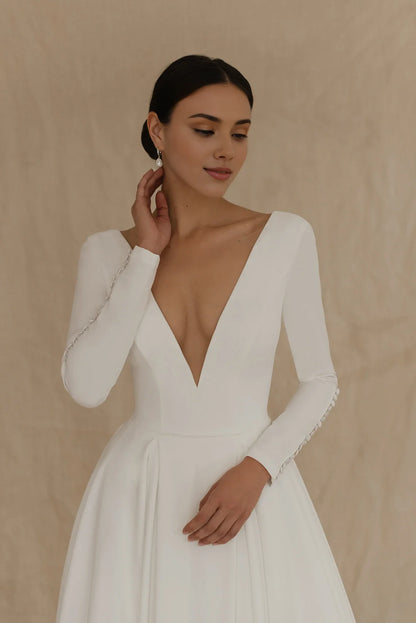 White Satin A‑Line Deep‑V Button‑Cuff Long‑Sleeve Open‑Back Chapel‑Train Wedding Dress For Church